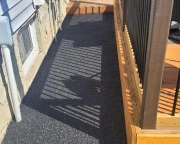 Rubber paved walkway alongside Dave's home