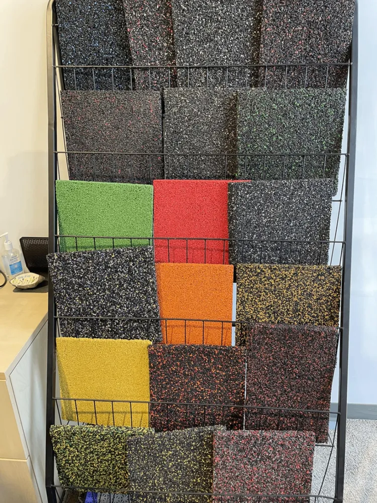 Rubber paving colour sample display rack showing solid and blended tones