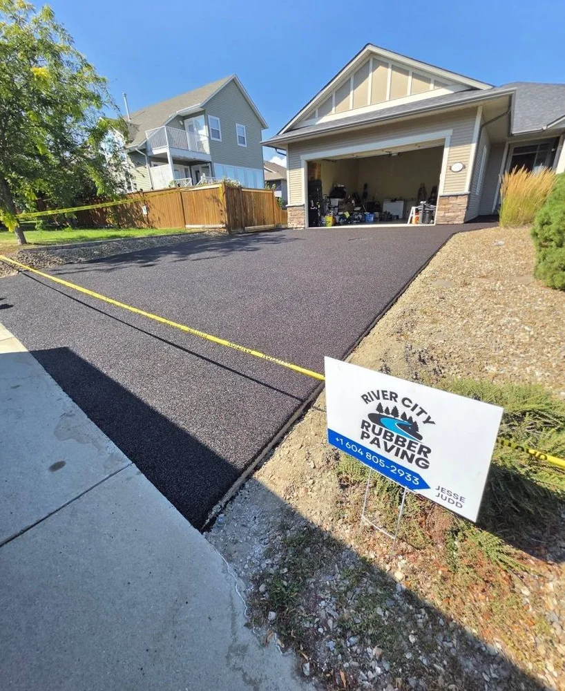 Brown blend rubber driveway with River City sign
