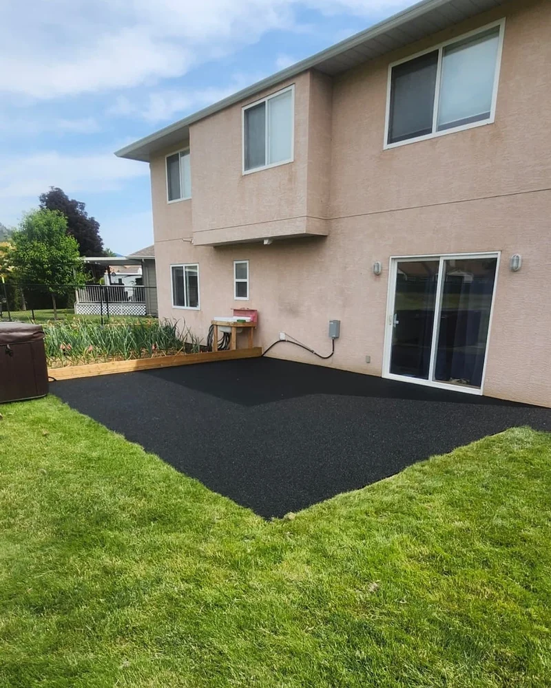 Black rubber backyard patio over concrete